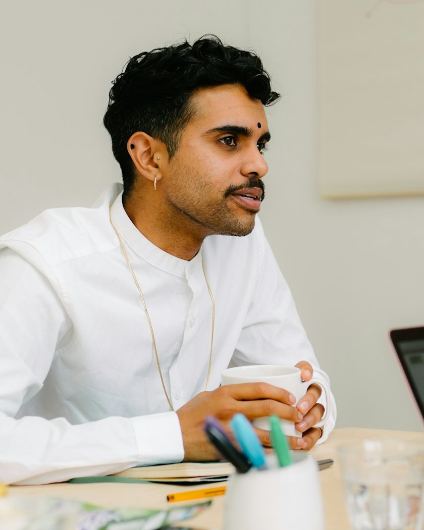 An employee at his desk, thinking during a working day