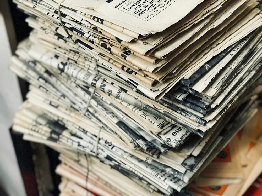 A tall stack of folded newspapers