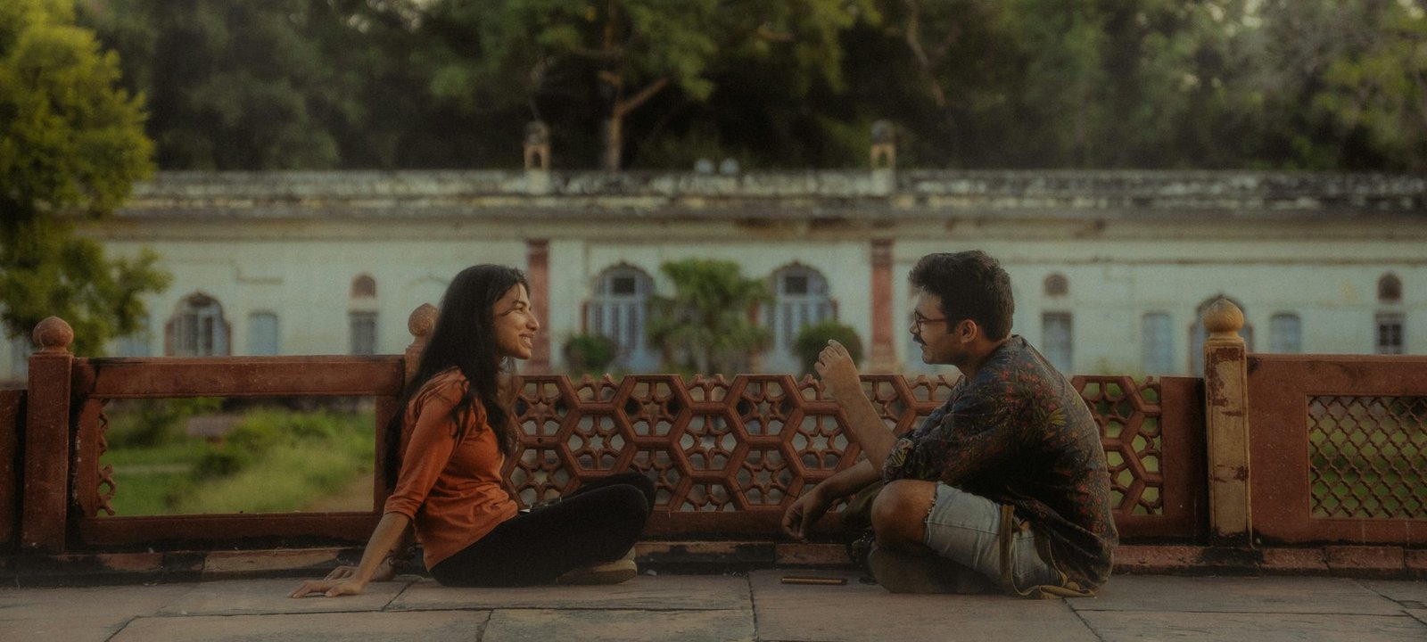 A young couple sitting on a terrace, talking