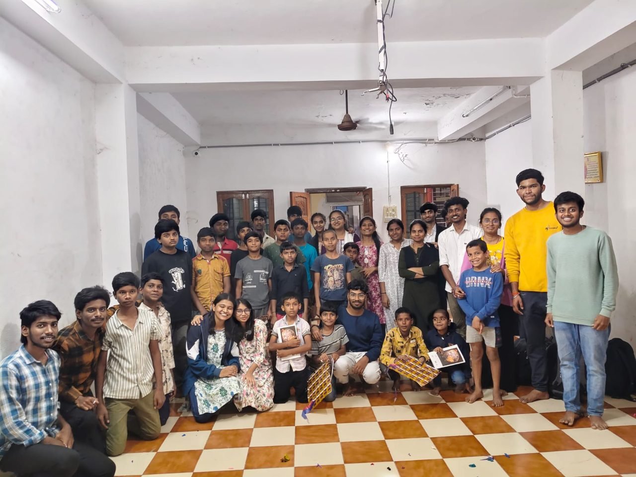 NAU volunteers together with a group of children after a community session