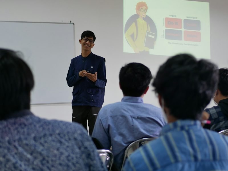 A student presenting to classmates in a college classroom