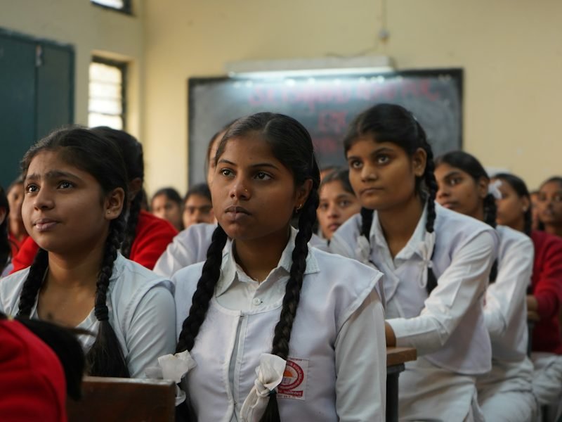 Schoolgirls in uniform listening during a class